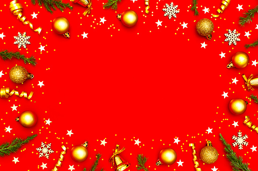 New Year Christmas composition. Frame from holiday decorations Christmas balls fir branches confetti snowflakes on red background. Flat lay top view copy space. Winter New Year 2020 Xmas celebration.