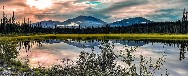 Regal mountain reflected upon a lake in the Wrangell St Elias national park and Preserve in Alaska