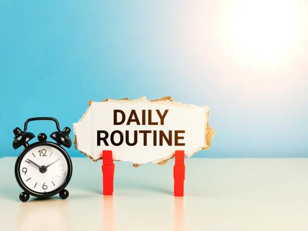 istock Cupboard strip written daily routine with alarm clock on the table. 1426123098