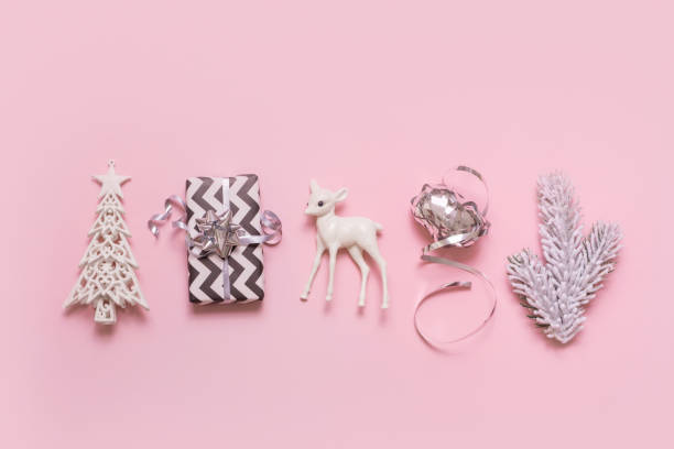 istock Festive minimal creative christmas composition with gift, deer, xmas tree flat lay on pink background 1426123124