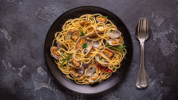 istock Seafood pasta with clams Spaghetti alle Vongole on a light background. Top view 1426123202