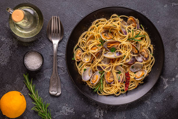 istock Seafood pasta with clams Spaghetti alle Vongole on a light background. Top view 1426123740