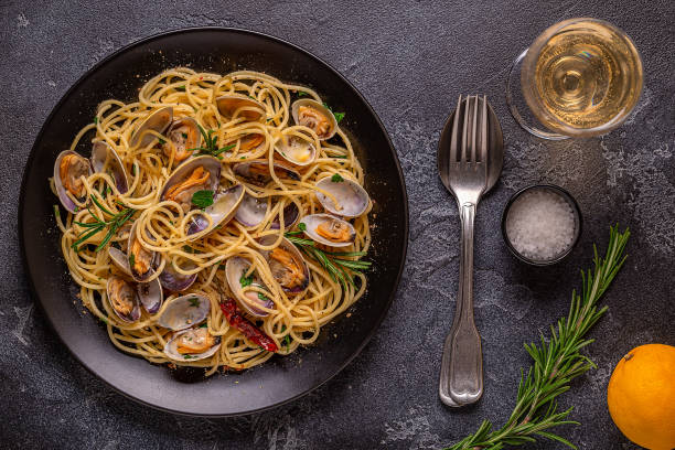 istock Seafood pasta with clams Spaghetti alle Vongole on a light background. Top view 1426123905