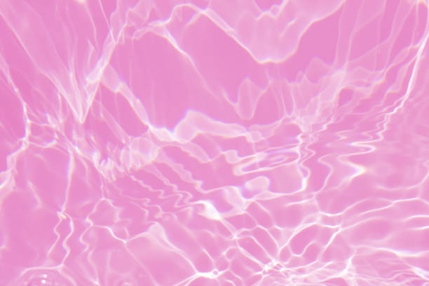 istock Defocus blurred transparent pink colored clear calm water surface texture with splash, bubble. Shining pink water ripple background. Surface of water in swimming pool. Tropical pink water color flow. 1426124536