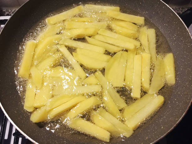 French fries, frying potatoes in a frying pan French fries, frying potatoes in cooking oil in a frying pan fried potato stock pictures, royalty-free photos & images