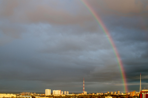 Rainbow in cloud sky over the panoramic city view