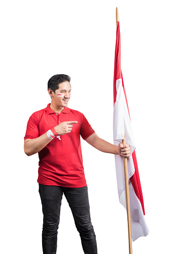Indonesian men celebrate Indonesian independence day on 17 August by holding the Indonesian flag isolated over white background