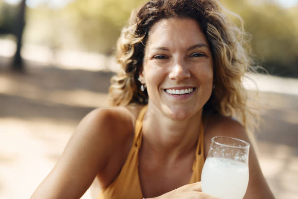istock Happy woman drinking lemonade in summer day. 1426133270