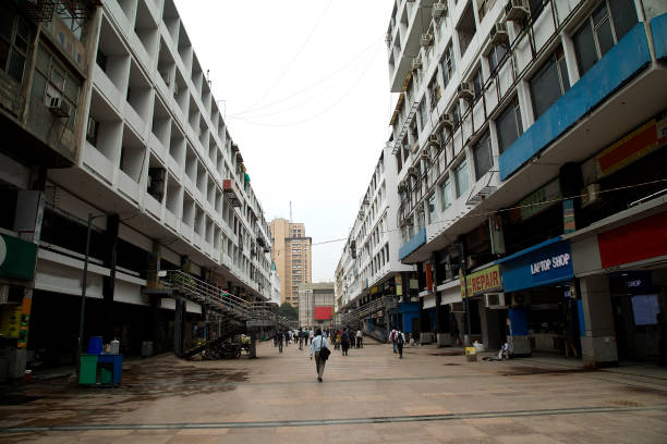 istock Commuters walking amidst buildings with retail shops 1426137725