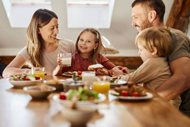 istock Young family talking during breakfast at dining table. 1426138312