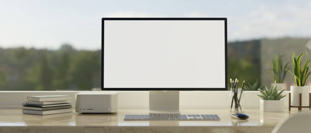 Computer screen mockup on white marble tabletop against the window with mountain view stock photo
