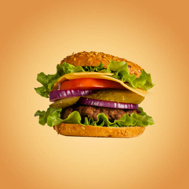 istock Hamburger, cheeseburger. Sandwich with cutlet, lettuce, tomatoes, pickled cucumbers, cheese, onion and bun. Close-up. 1426138614