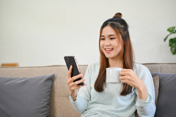 istock Beautiful Asian woman using her smartphone, scrolling on her social media 1426138862