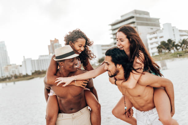 istock friends piggyback on the beach 1426141863