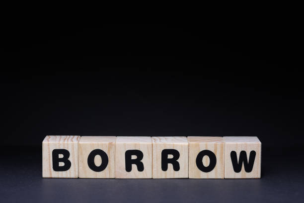 istock Borrow word on wooden cubes on black background 1426142294
