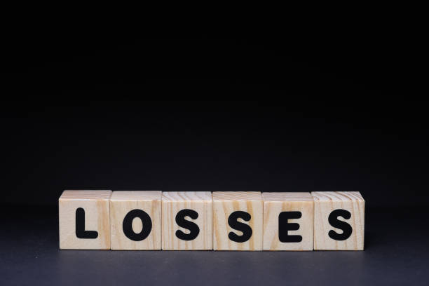 Word losses from wooden blocks on black background