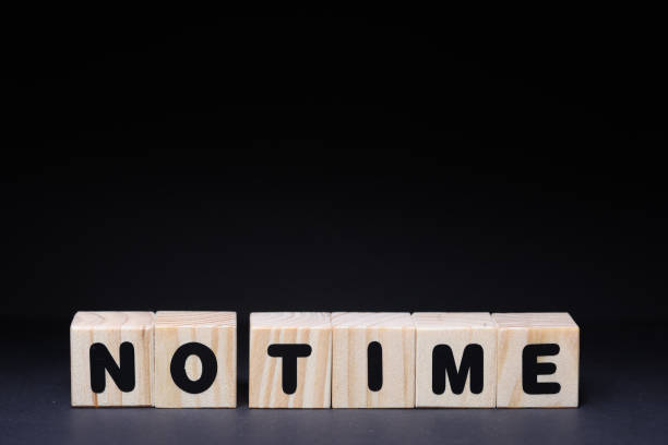 istock No time word on wooden cubes on black background 1426142582