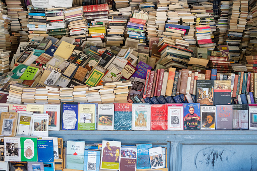 Madrid, Spain - September 9, 2022: Stacks of used books on sale in famous book stalls of Cuesta de Moyano