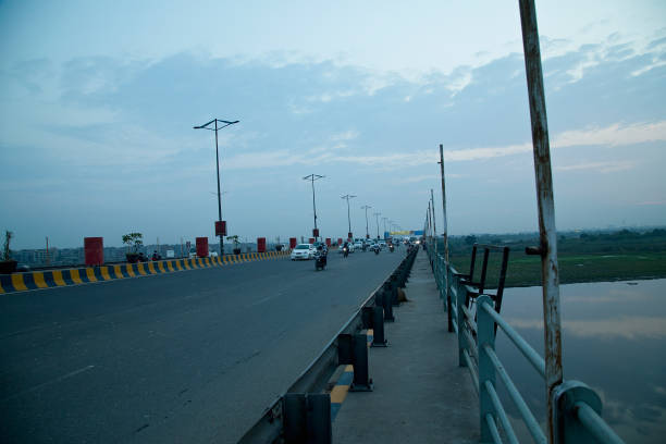 istock Road traffic and lake against cloudy sky 1426148072