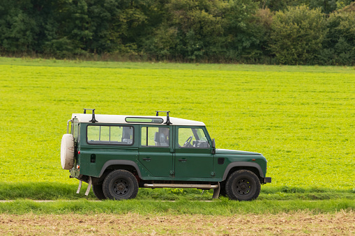 Montalcino, Italy - June 11, 2021 : The New Land Rover Defender parked on the italian summer countryside .