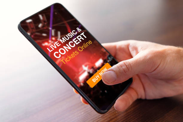 Person buying music concert tickets online on mobile phone stock photo