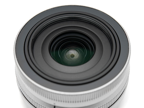 Digital camera lens close-up over white background