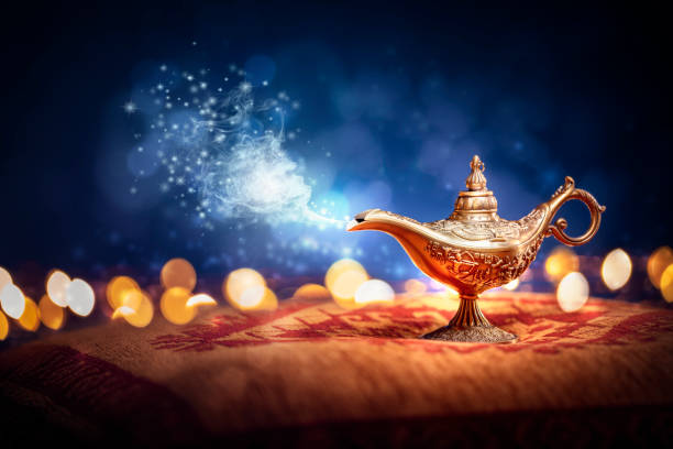 Aladdins Genie lamp magic background Magic lamp from the story of Aladdin with Genie appearing in blue smoke concept for wishing, luck and magic pantomime stock pictures, royalty-free photos & images