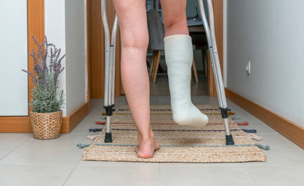 istock Woman walking on carpet with broken leg 1426161864