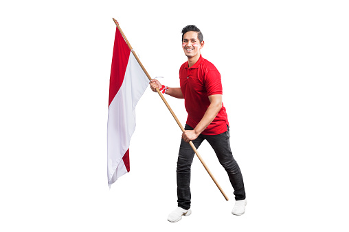 Indonesian men celebrate Indonesian independence day on 17 August by holding the Indonesian flag isolated over white background
