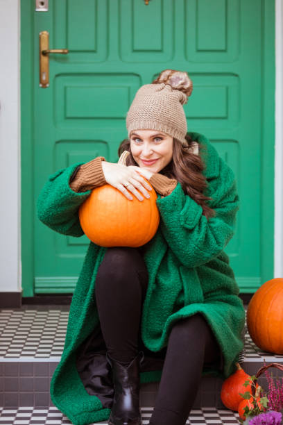 istock Happy woman holding pumpkin 1426164387