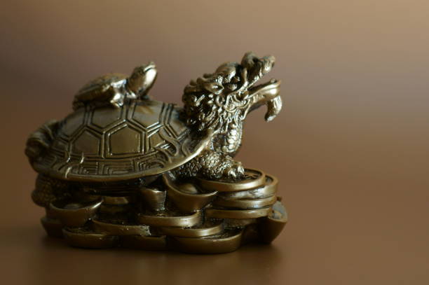 istock Dragon turtle on a brown background. A religious symbol. 1426164394