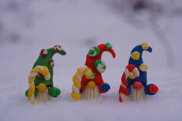 istock Three colorful dwarfs with a Christmas candy cane in their hand. 1426164980