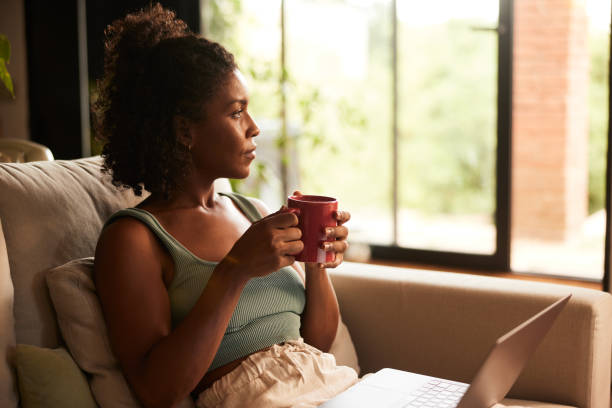 istock Adult online learning coffee break looks through window. 1426178344