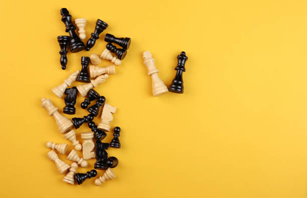 istock chess pieces randomly lie on a yellow background 1426179064