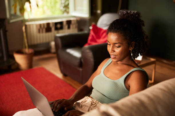 istock Adult online student learning with a laptop on a sofa. 1426179367