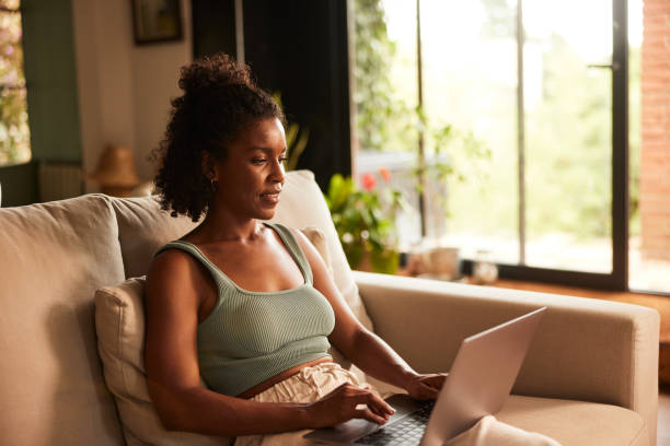 istock Adult online student learning with a laptop on a sofa. 1426179409