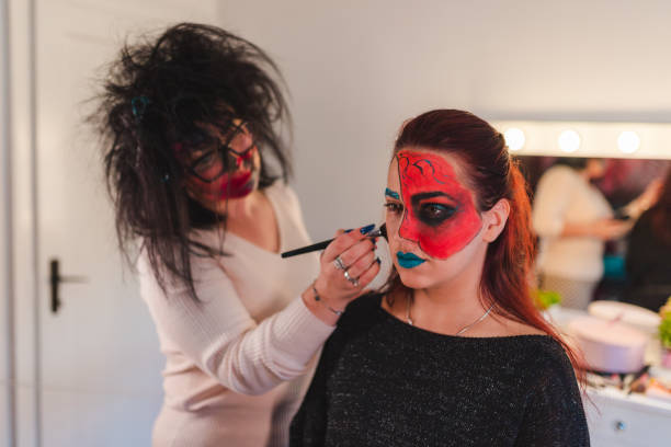 istock Two young women getting ready for Halloween by getting their makeup done 1426181499
