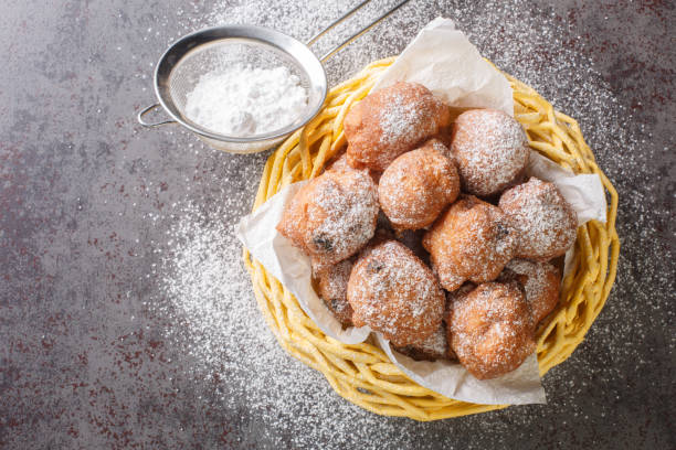 istock Dutch oliebollen with icing sugar closeup in the basket. Horizontal top view 1426182585