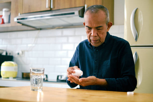 istock Asian senior male taking pills. 1426187906