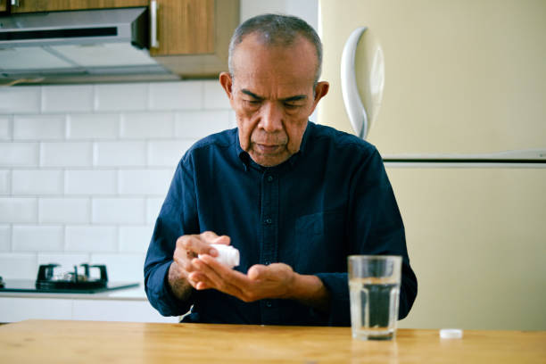 istock Asian senior male taking pills. 1426187912
