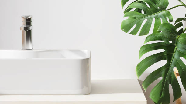 istock Modern and minimal design of bathroom vanity with marble counter top and white rectangle ceramic washbasin and Monstera plants in sunlight from window 1426189283