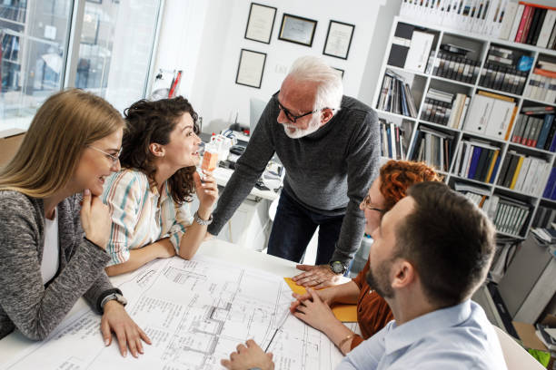 istock Working day in a design studio. Group of designers and architects on meeting. 1426193133