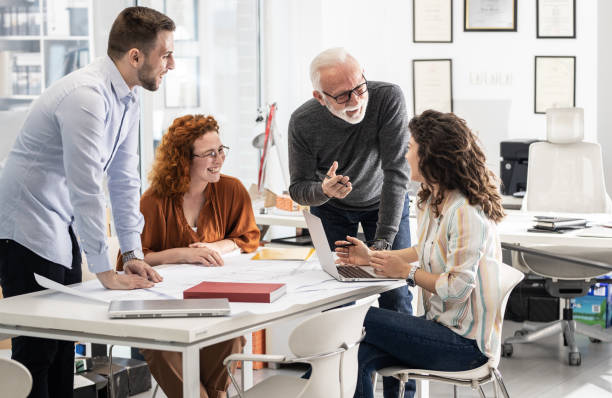 istock Working day in a design studio. Group of designers and architects on meeting. 1426193362