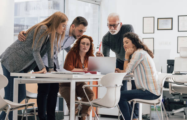 istock Working day in a design studio. Group of designers and architects on meeting. 1426193413