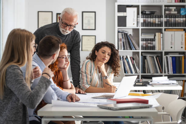 istock Working day in a design studio. Group of designers and architects on meeting. 1426193417