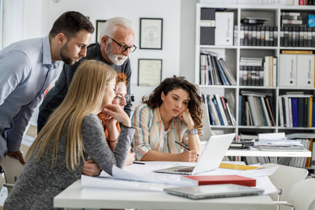 istock Working day in a design studio. Group of designers and architects on meeting. 1426193464