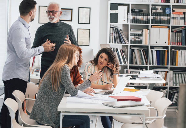 istock Working day in a design studio. Group of designers and architects on meeting. 1426193468