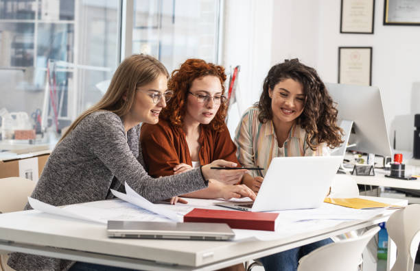 istock Working day in a design studio. Group of designers and architects on meeting. 1426193556