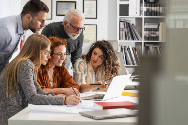 istock Working day in a design studio. Group of designers and architects on meeting. 1426193569