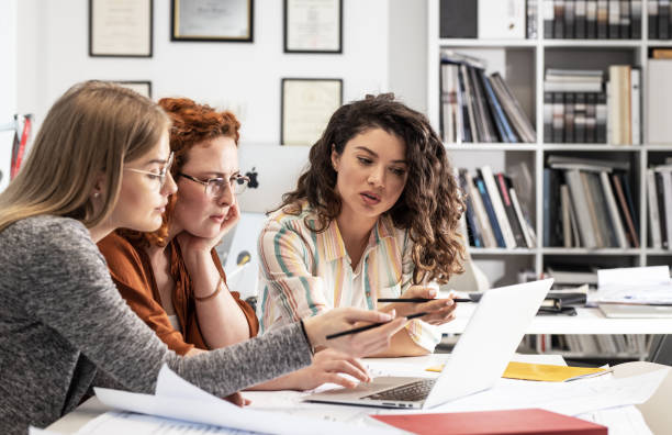 istock Working day in a design studio. Group of designers and architects on meeting. 1426193659